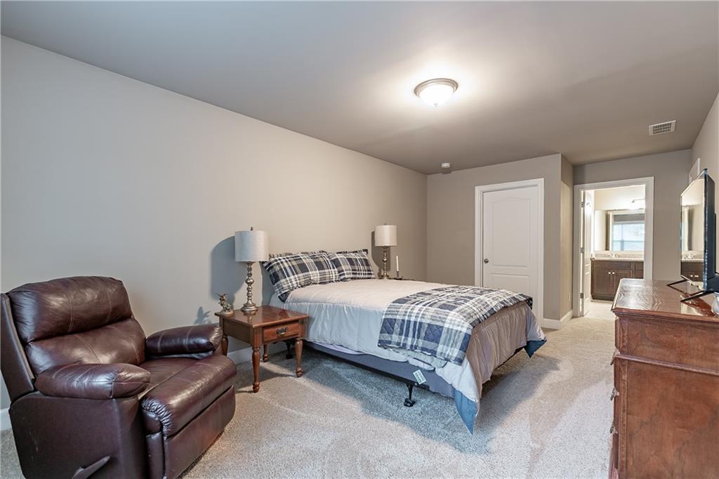2875 Fox Wood Lane Gainesville, GA 30504 - Photo 23 of 24 a bedroom with a bed and a couch