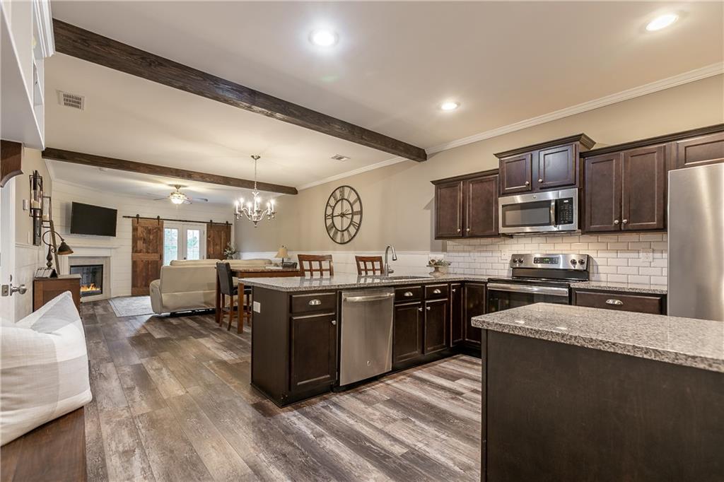 2875 Fox Wood Lane Gainesville, GA 30504 - Photo 3 of 24 a large kitchen with stainless steel appliances and wooden cabinets