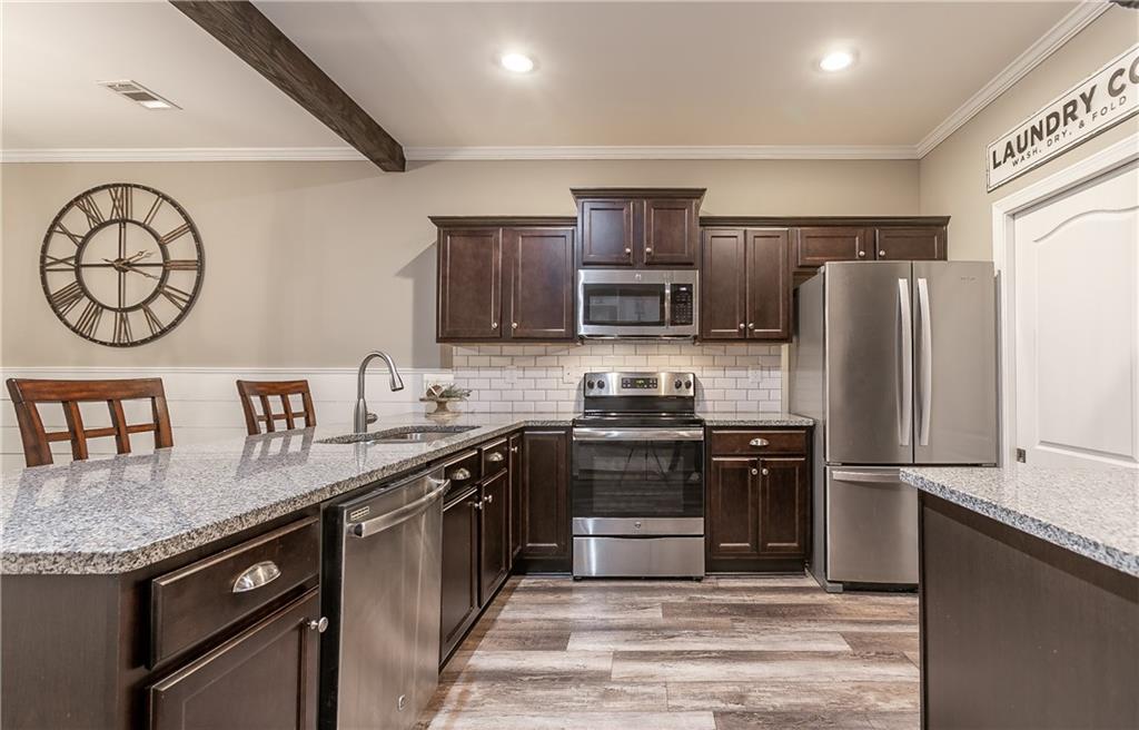 2875 Fox Wood Lane Gainesville, GA 30504 - Photo 4 of 24 a kitchen with stainless steel appliances granite countertop a stove a refrigerator and a sink