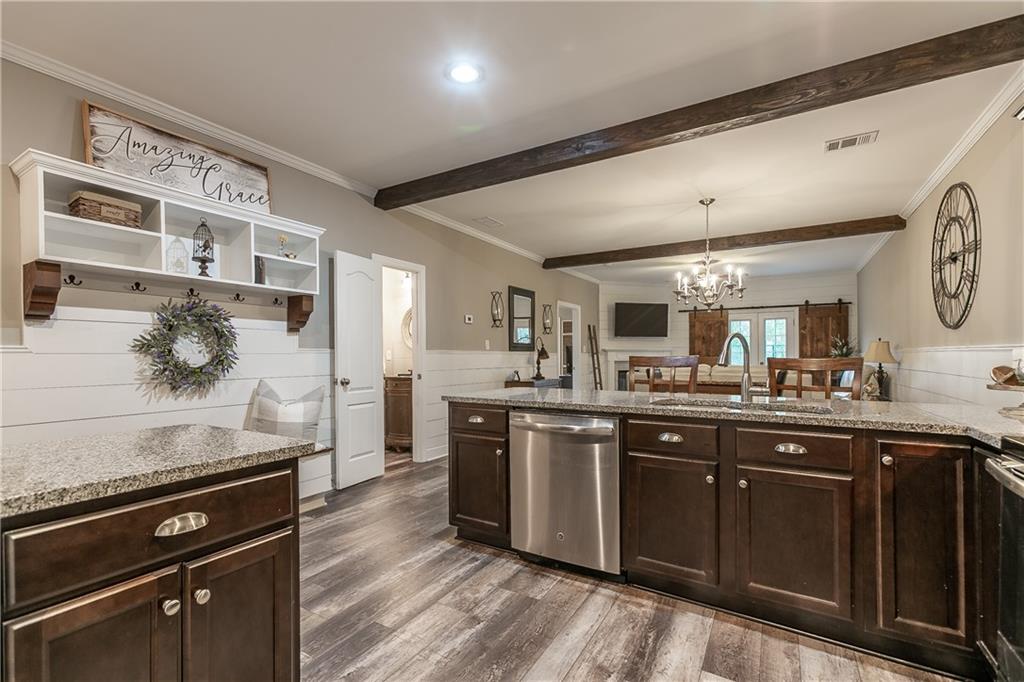 2875 Fox Wood Lane Gainesville, GA 30504 - Photo 5 of 24 a kitchen with stainless steel appliances granite countertop a stove and a sink