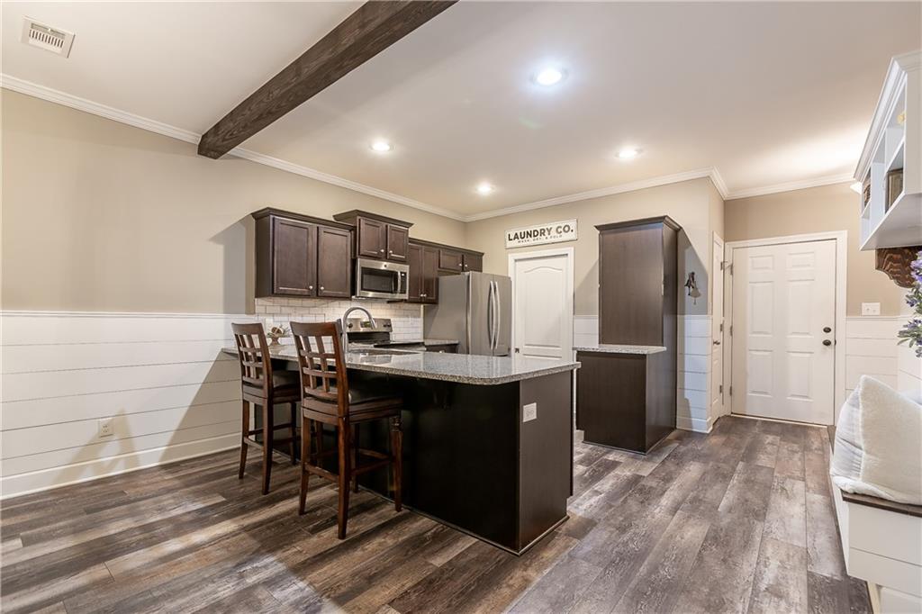 2875 Fox Wood Lane Gainesville, GA 30504 - Photo 8 of 24 a kitchen with stainless steel appliances a microwave a sink a stove a refrigerator cabinets and wooden floor