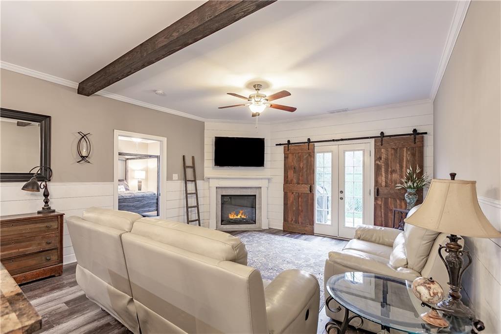 2875 Fox Wood Lane Gainesville, GA 30504 - Photo 10 of 24 a living room with furniture a fireplace and a flat screen tv