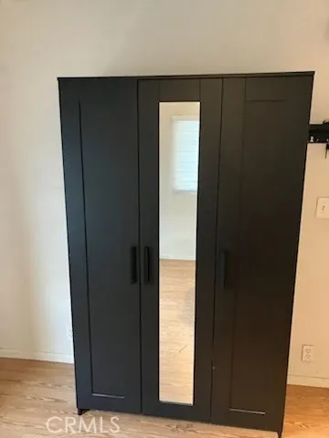 an entryway door with wooden floor