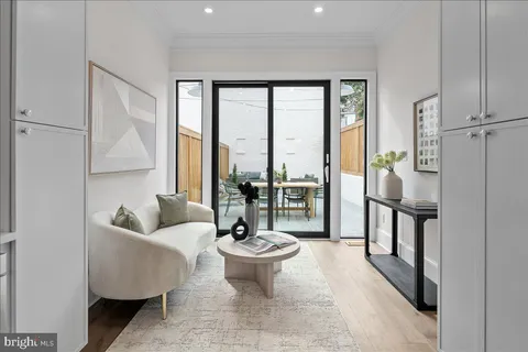 a living room with furniture and a floor to ceiling window