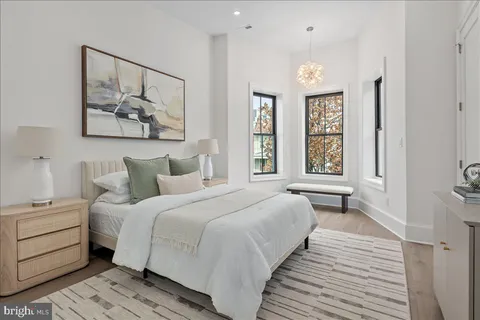 a spacious bedroom with a bed and a window