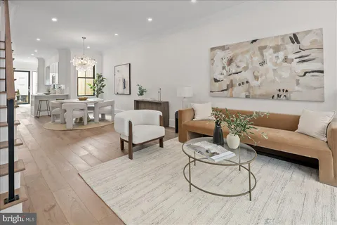 a living room with furniture and a painting on the wall