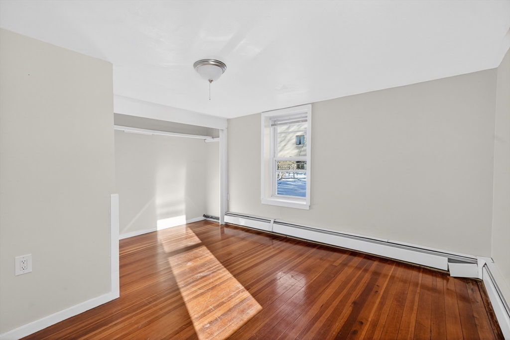 240 Montaup Street Fall River, MA 02724 - Photo 3 of 16 a view of an empty room with wooden floor and a window