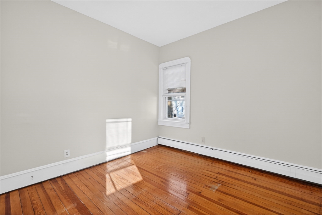 240 Montaup Street Fall River, MA 02724 - Photo 7 of 16 an empty room with wooden floor and windows