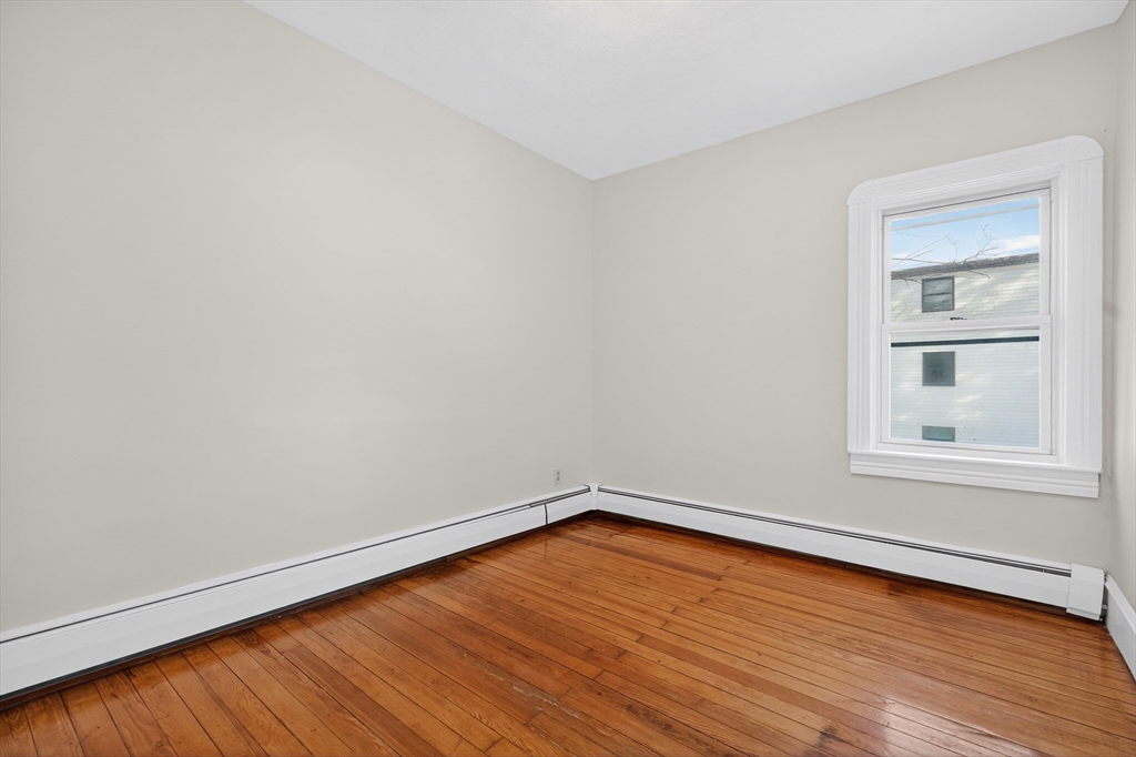 240 Montaup Street Fall River, MA 02724 - Photo 9 of 16 an empty room with wooden floor and windows