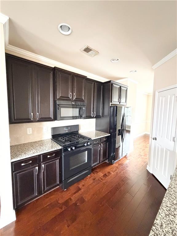 4954 Rosalie Road Alpharetta, GA 30022 - Photo 5 of 21 a kitchen with stainless steel appliances granite countertop a stove a sink and a refrigerator