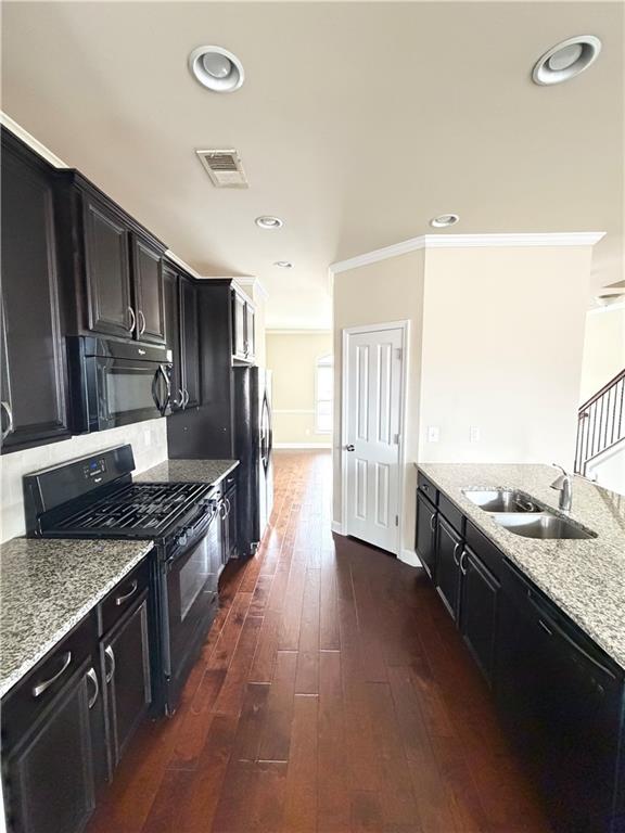 4954 Rosalie Road Alpharetta, GA 30022 - Photo 6 of 21 a large kitchen with stainless steel appliances granite countertop a stove a sink dishwasher and a refrigerator