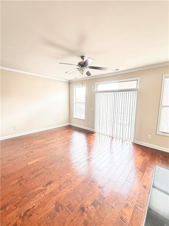 4954 Rosalie Road Alpharetta, GA 30022 - Photo 8 of 21 wooden floor in an empty room with a window
