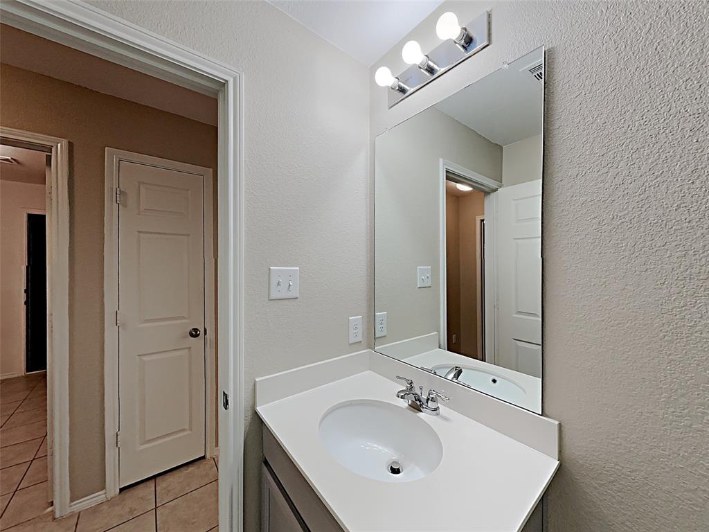 2220 Heaton Street Forney, TX 75126 - Photo 9 of 11 a bathroom with a sink vanity and mirror