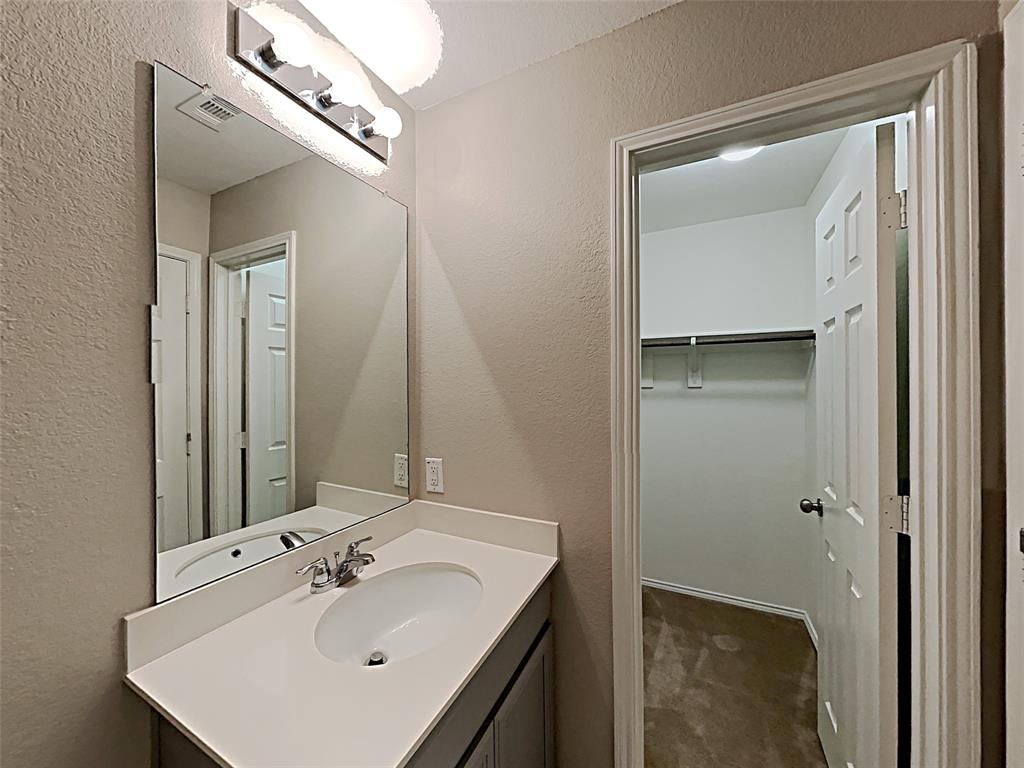 2220 Heaton Street Forney, TX 75126 - Photo 10 of 11 a bathroom with a sink mirror and vanity