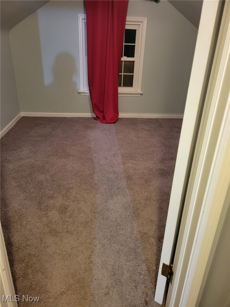 2440 Midvale Road Northwest Canton, OH 44708 - Photo 13 of 22 Additional living space featuring carpet flooring and lofted ceiling