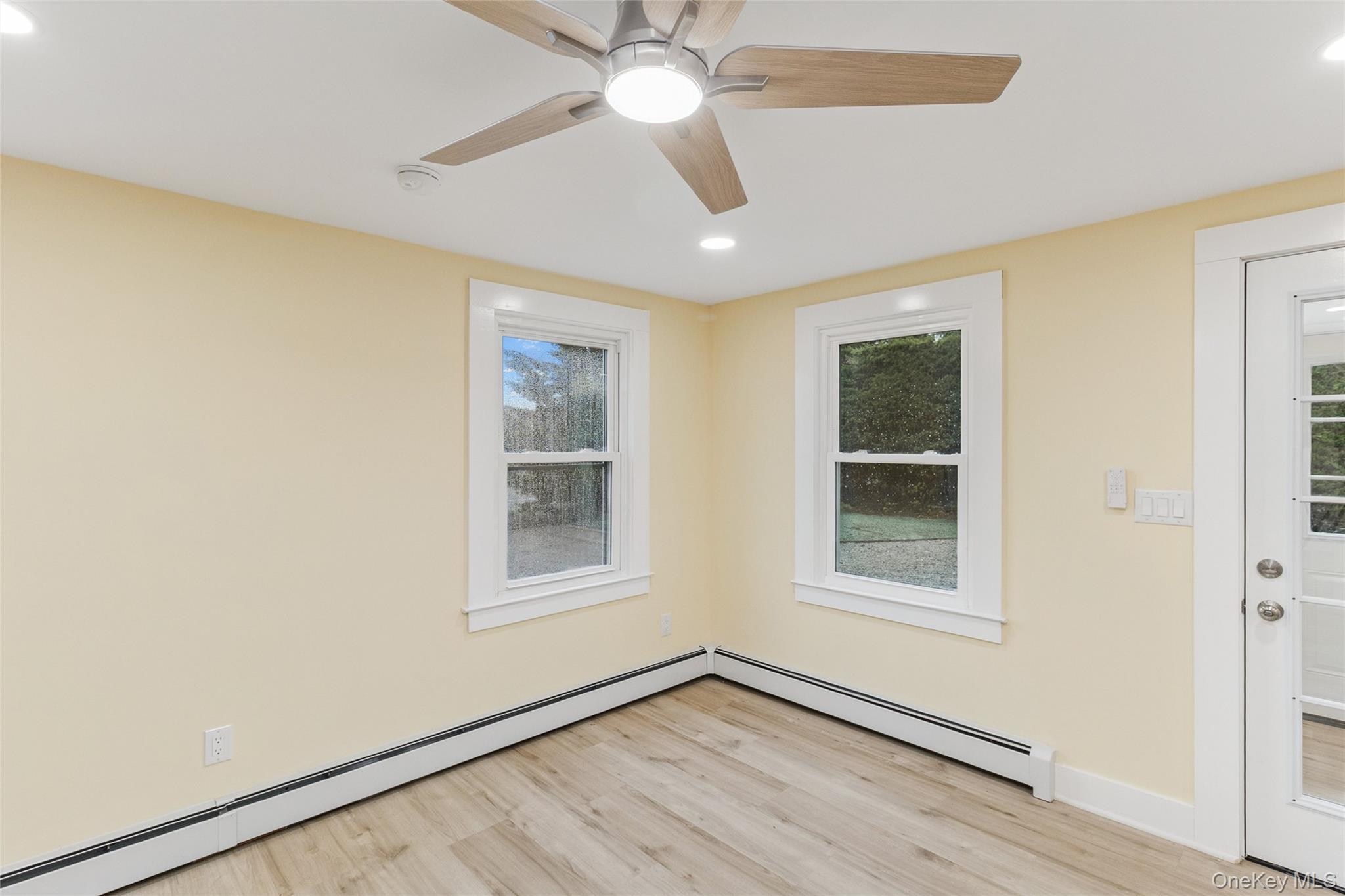 17425 County Road 48 Cutchogue, NY 11935 - Photo 24 of 30 Empty room featuring a baseboard heating unit, recessed lighting, light wood-type flooring, and a ceiling fan