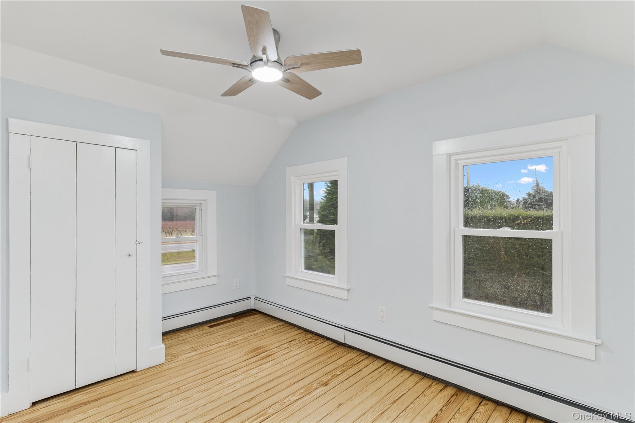17425 County Road 48 Cutchogue, NY 11935 - Photo 27 of 30 Bonus room featuring lofted ceiling, a baseboard heating unit, healthy amount of natural light, light wood-type flooring, and a ceiling fan