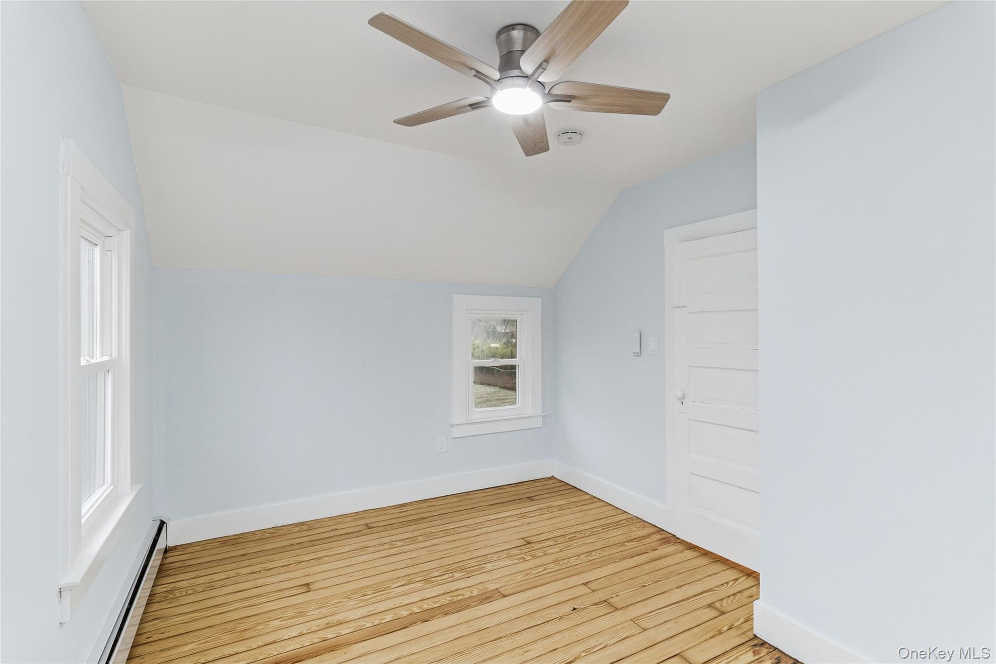 17425 County Road 48 Cutchogue, NY 11935 - Photo 28 of 30 Additional living space featuring a baseboard heating unit, vaulted ceiling, light wood-style floors, and ceiling fan