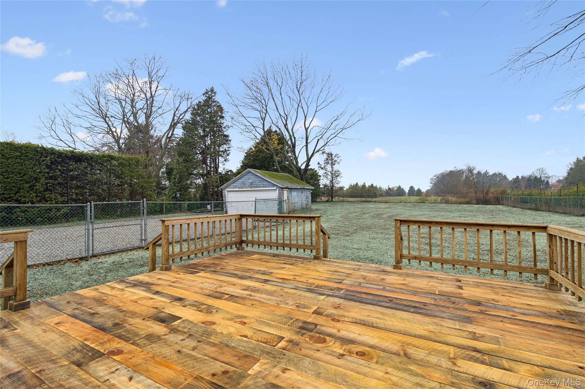 17425 County Road 48 Cutchogue, NY 11935 - Photo 10 of 30 Wooden deck with a detached garage and an outbuilding