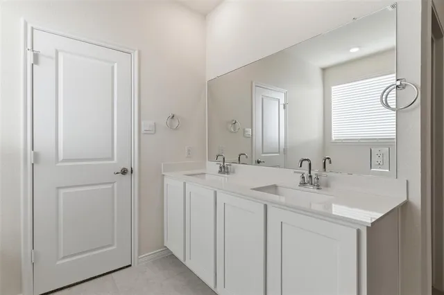 a bathroom with 2 sink and a mirror