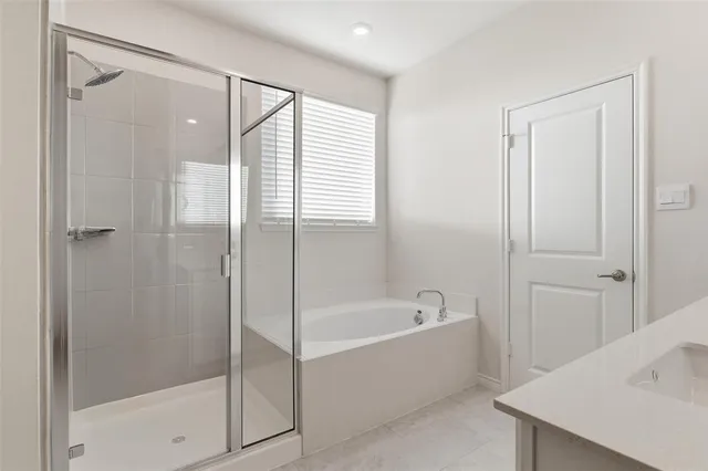 a bathroom with a bathtub and shower