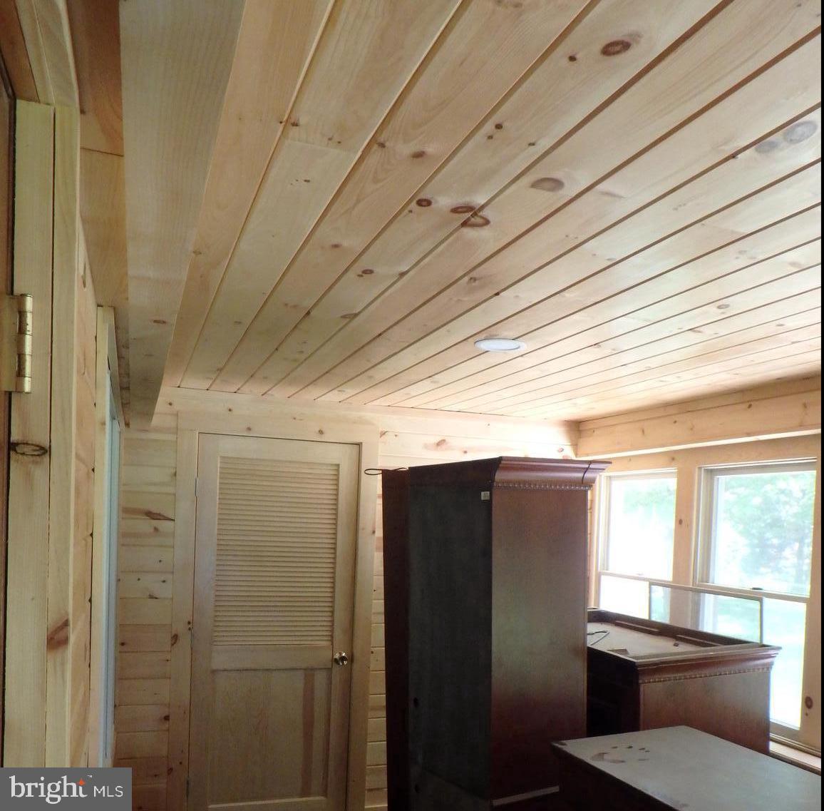 5299 Skinners Neck Road Rock Hall, MD 21661 - Photo 20 of 38 New knotty pine paneling in Sunroom