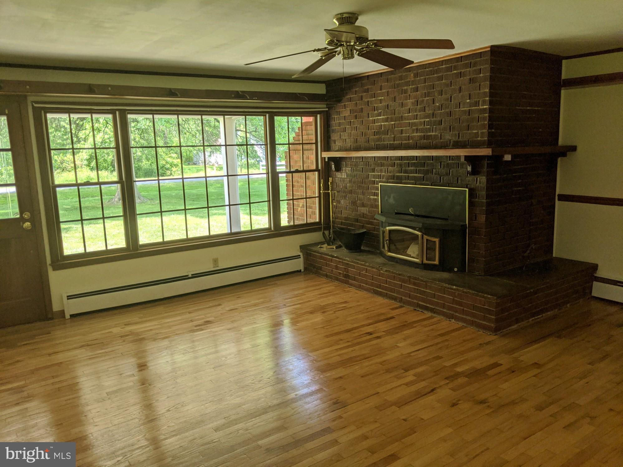 5299 Skinners Neck Road Rock Hall, MD 21661 - Photo 3 of 38 Family room fireplace w/insert refinished Hardwood
