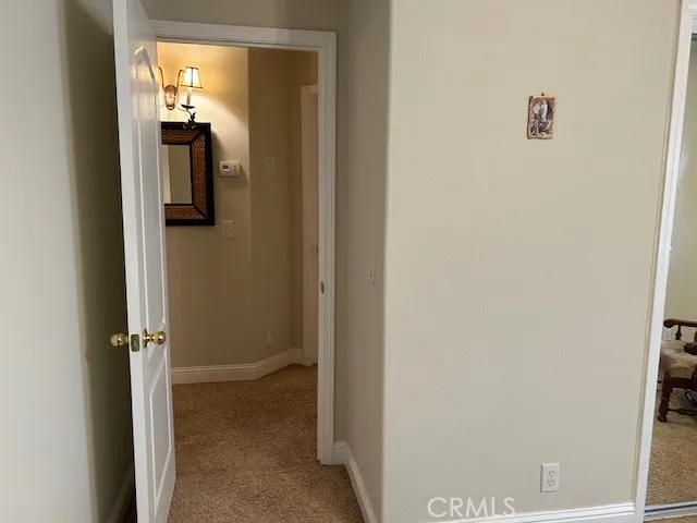 a patio with a table and chairs under an umbrella