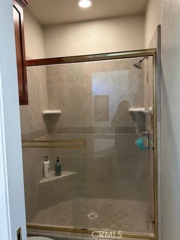 a view of a patio with table and chairs under an umbrella