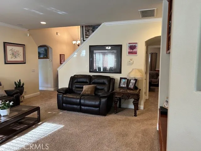 a living room with furniture and a mirror