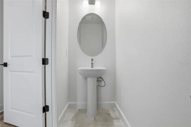a bathroom with a sink and mirror