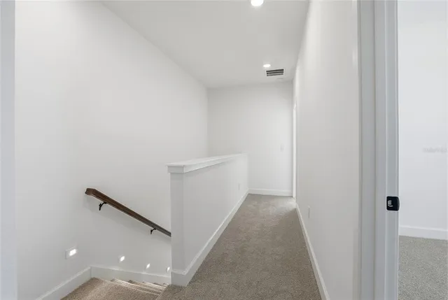 a view of a hallway with white walls