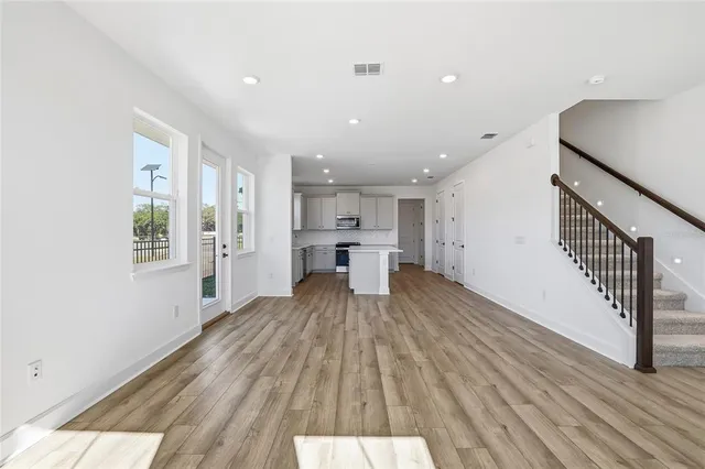a view of kitchen with wooden floor and electronic appliances