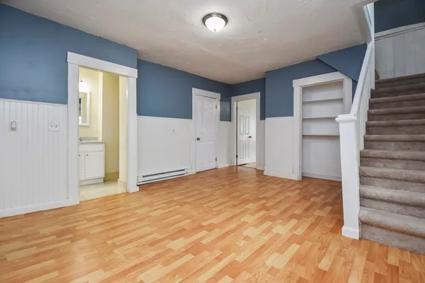 a view of empty room with wooden floor