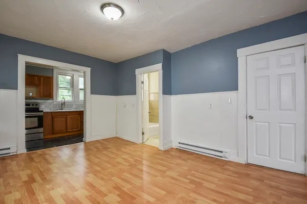 a view of a kitchen with wooden cabinet and a refrigerator