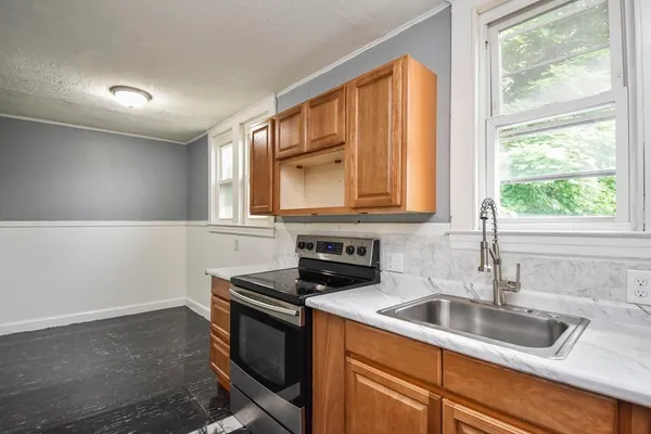 a kitchen with granite countertop a sink and a window