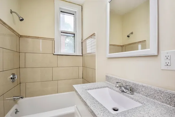 a bathroom with a tub and a sink