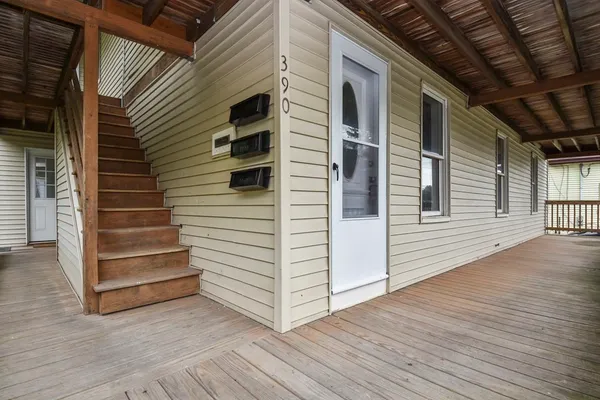 a view of a house with a door and wooden floor