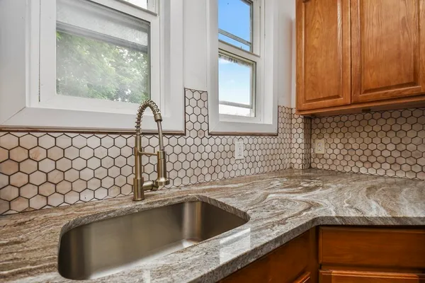 a kitchen with a sink and a window