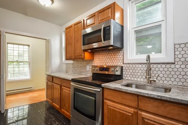 a kitchen with stainless steel appliances a stove sink and microwave