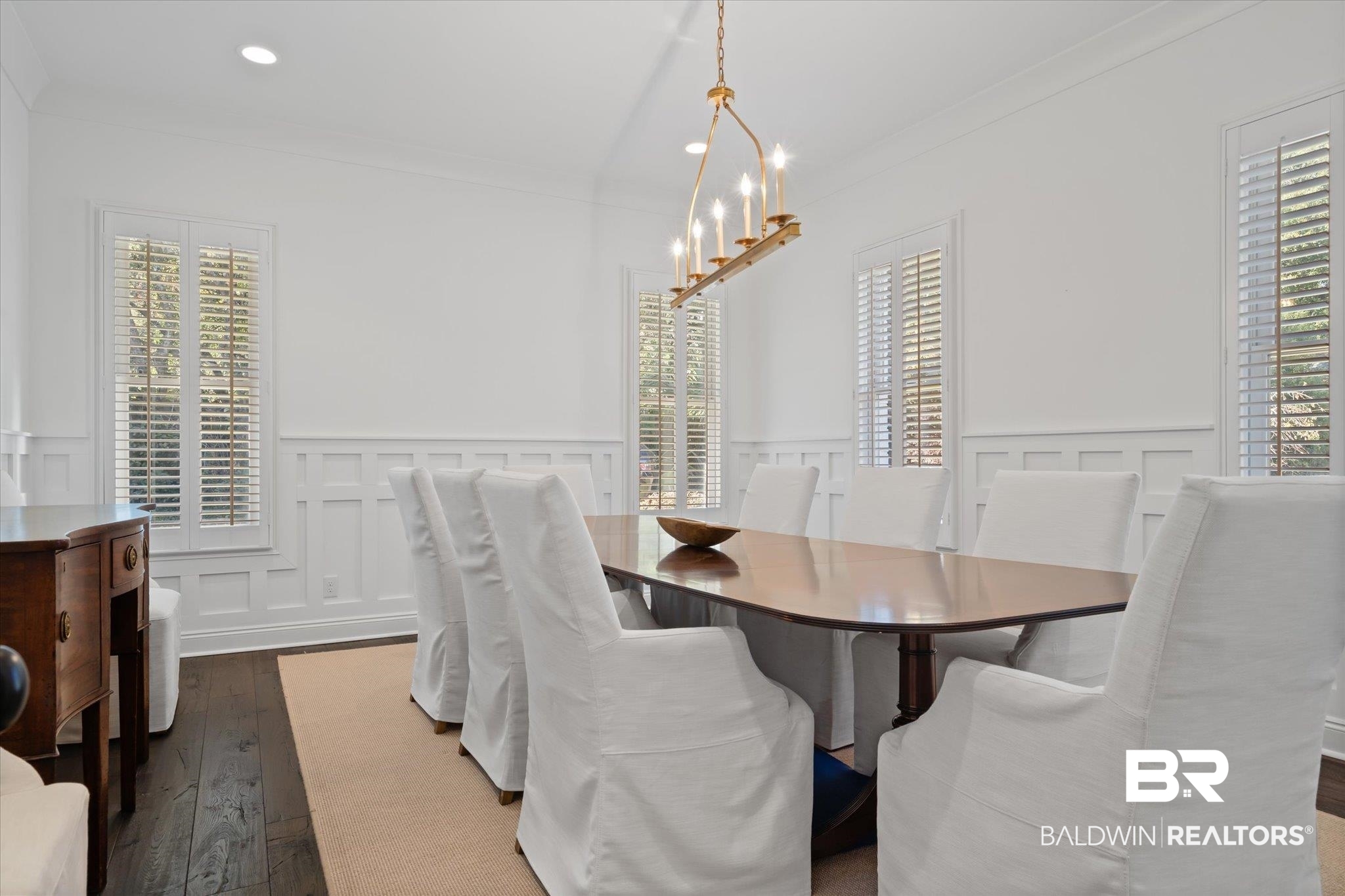 3713 Old Shell Road Mobile, AL 36608 - Photo 9 of 52 Dining area with a healthy amount of sunlight, dark hardwood / wood-style flooring, crown molding, and an inviting chandelier