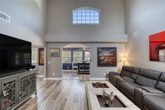 a living room with furniture window and wooden floor