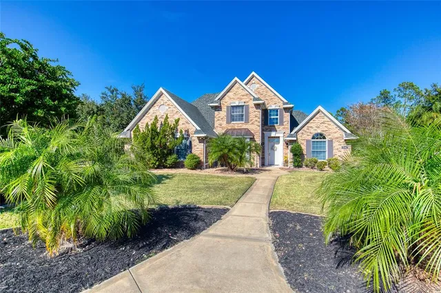 a view of a house with yard and a garden
