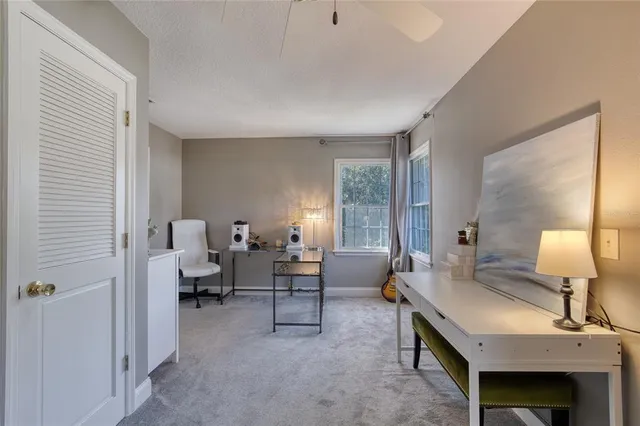 an aerial view of residential houses with outdoor space and trees