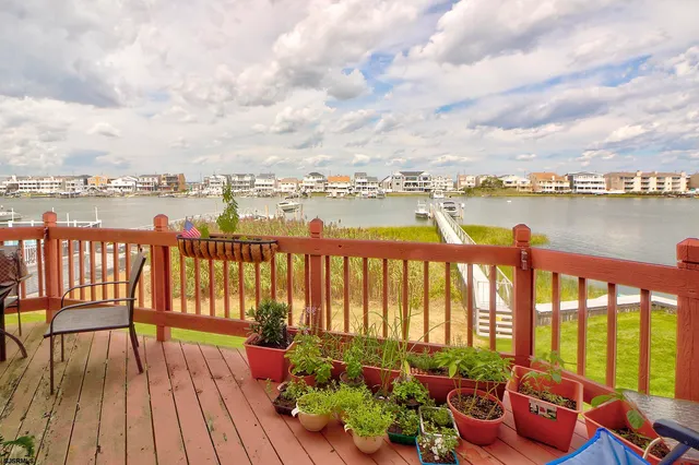 a balcony with wooden floor and lake view