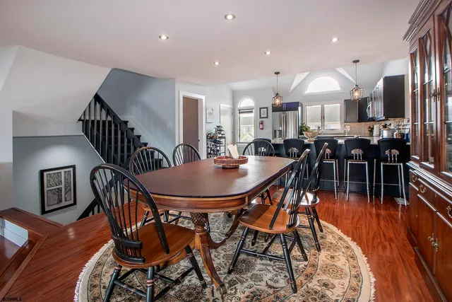 a dining room with furniture and wooden floor