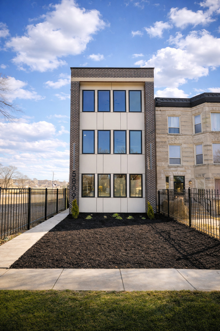 5809 South Indiana Avenue, Unit 2 Chicago, IL 60637 - Photo 1 of 18 a front view of a house with a yard
