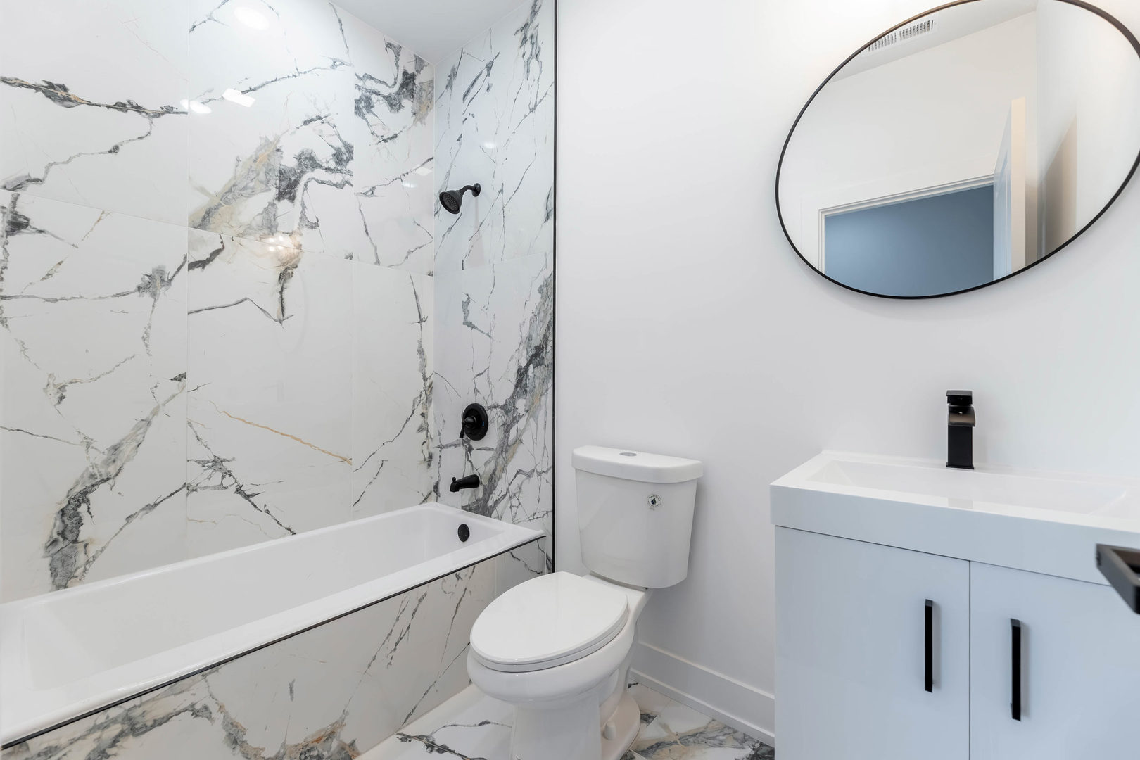 5809 South Indiana Avenue, Unit 2 Chicago, IL 60637 - Photo 15 of 18 a bathroom with a sink toilet and shower