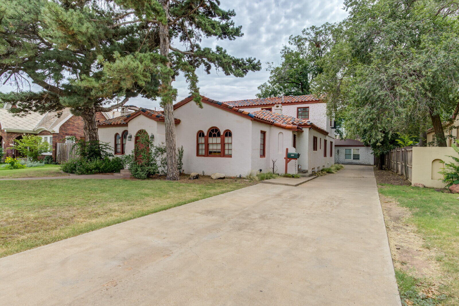 2305 18th Street, Unit FRONT Lubbock, TX 79401 - Photo 2 of 73 a view of a white house with a yard and large tree