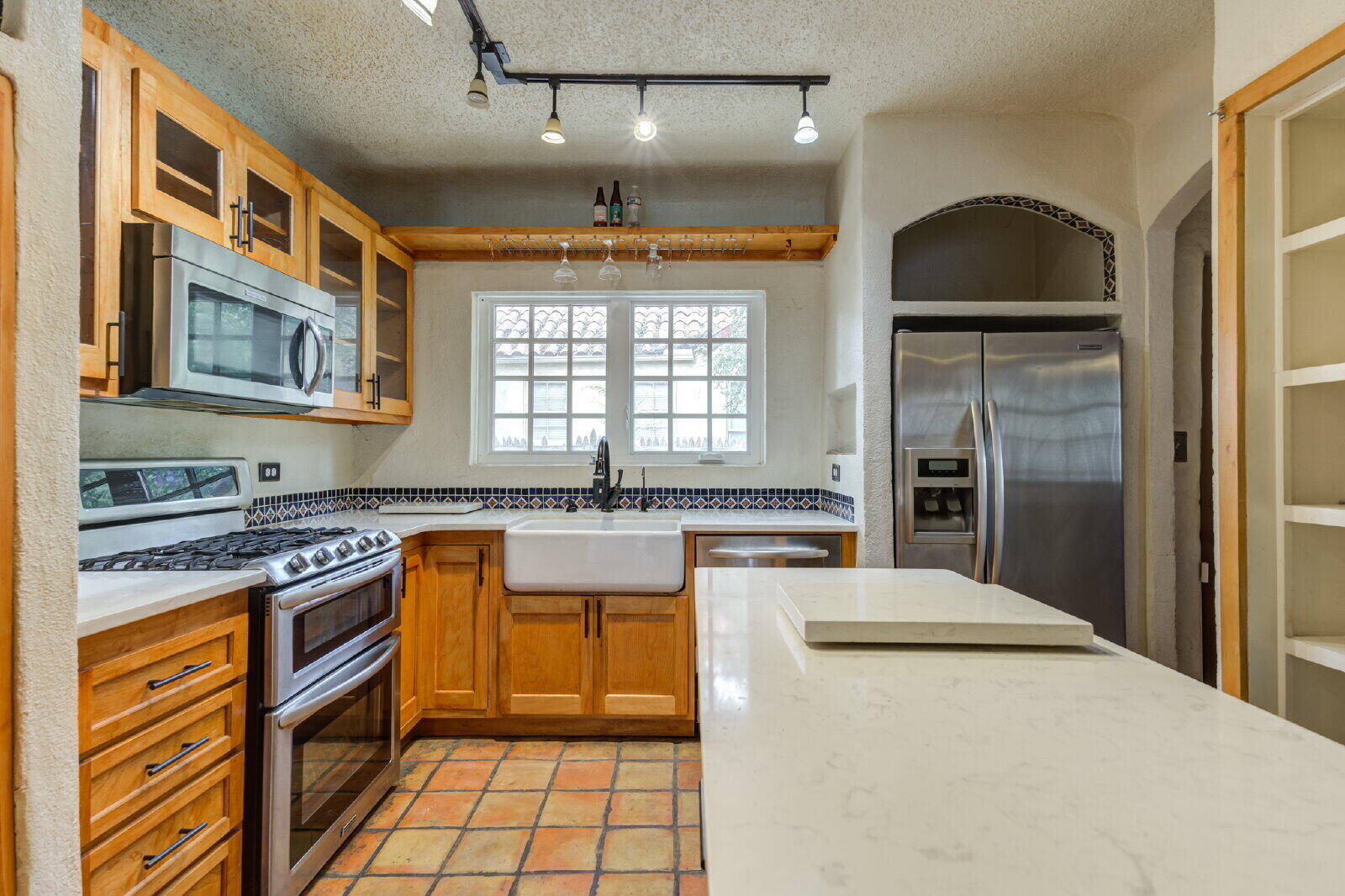 2305 18th Street, Unit FRONT Lubbock, TX 79401 - Photo 21 of 73 a kitchen with stainless steel appliances granite countertop a stove a sink and a refrigerator